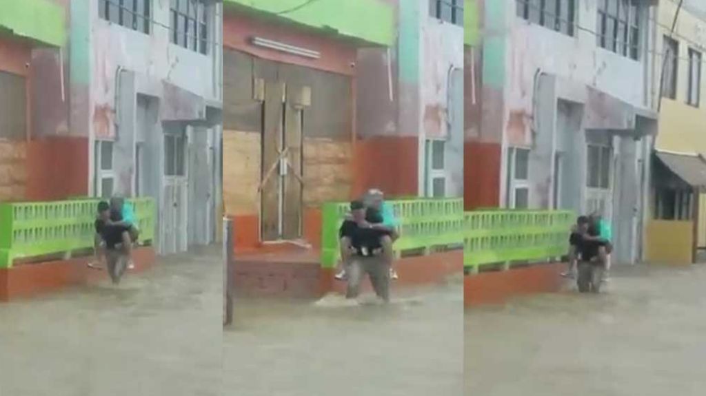 Video de un policía de Arecibo que rescato una mujer en el huracán montándola en su espalda 